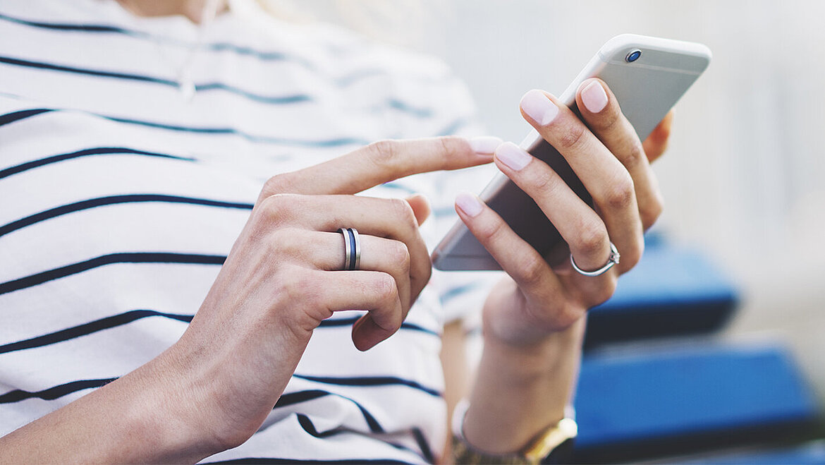 Person with smartphone in her hand